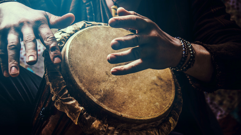 A,Man,Playing,An,Ethnic,Percussion,Musical,Instrument,Jembe.,Drummer A,Man,Playing,An,Ethnic,Percussion,Musical,Instrument,Jembe.,Drummer